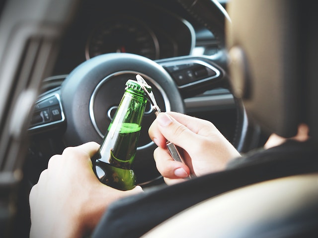 person drinking while driving