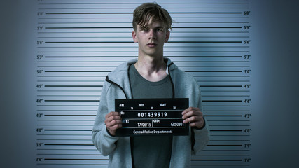 man taking mugshot photo