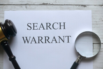 gavel and paper that says search warrant